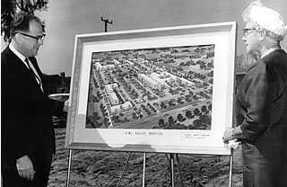 William H. Gosse, the first administrator of Simi Valley Community Hospital, reviews an artist's rendering of building plans with Honorary Mayor Mrs. Lou Wright.